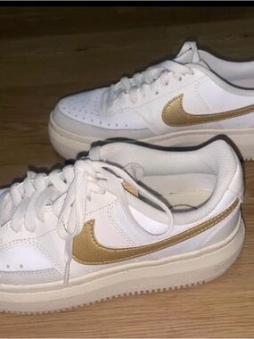 Nike Women's White Sneakers with Gold Swoosh